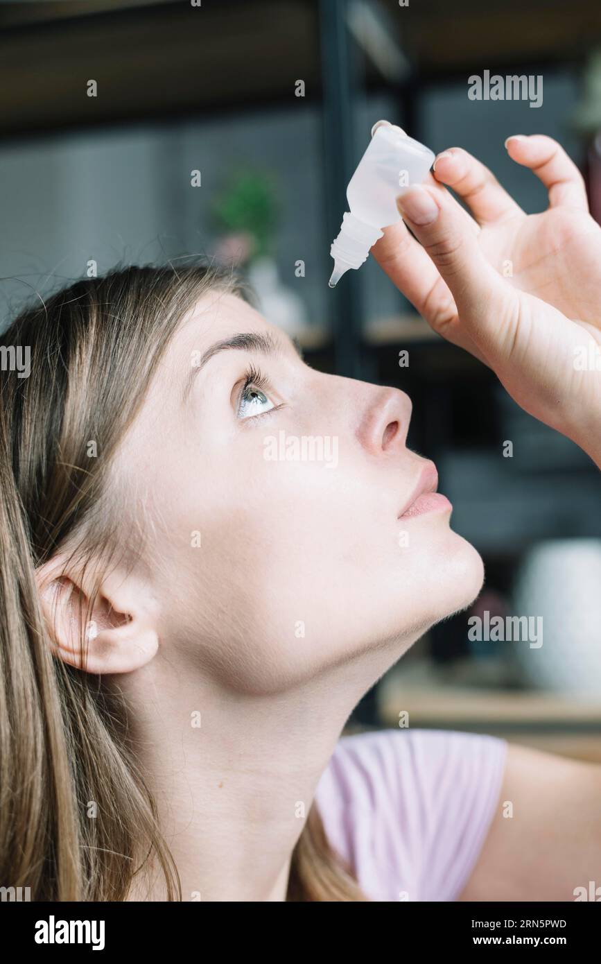Close up woman putting eye drops Stock Photo Alamy