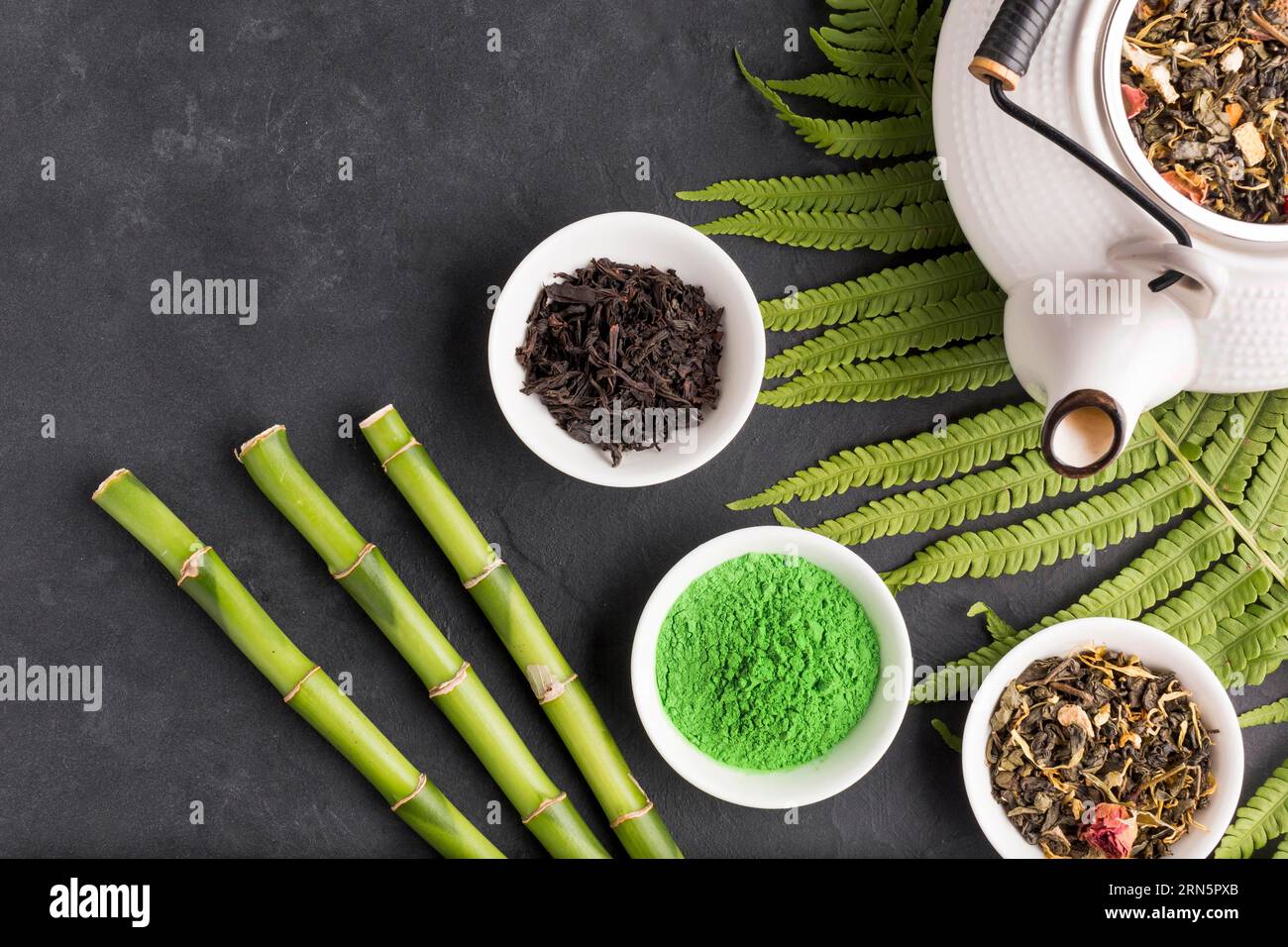 Collection aromatic dry tea ingredient black surface Stock Photo Alamy