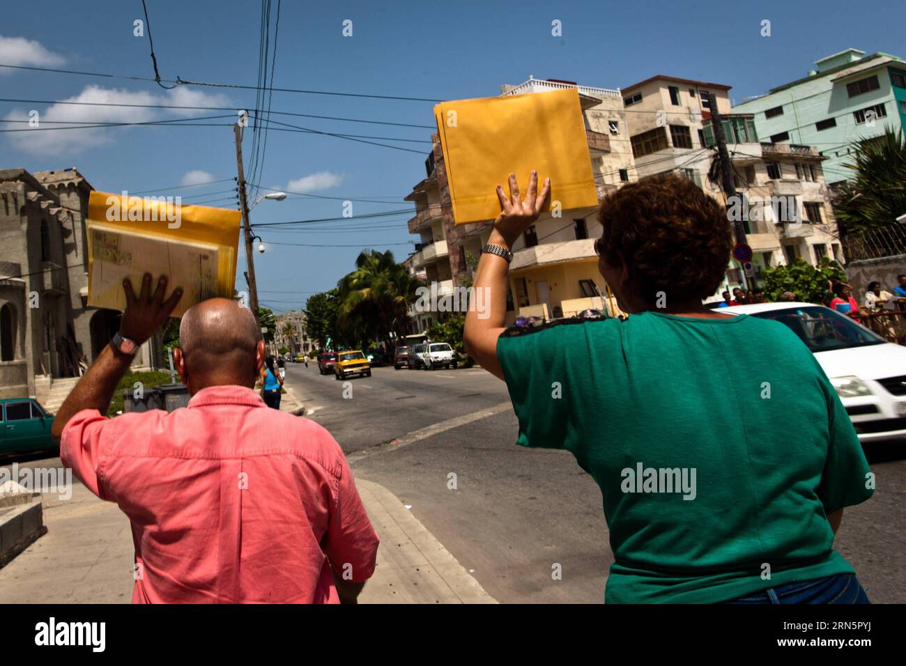 (150701) -- HAVANA, July 1, 2015 -- Local people hold application meterials of U.S. visas outside of the U.S. Interests Section in Havana, Cuba, July 1, 2015. After five decades of icy relations and more than six months of negotiations, Cuba and the United States will restore diplomatic relations and reopen their embassies in their respective capitals as of July 20, an official release said Wednesday. ) CUBA-HAVANA-US-DIPLOMATIC RELATIONS-REESTABLISHMENT liuxbin PUBLICATIONxNOTxINxCHN   150701 Havana July 1 2015 Local Celebrities Hold Application meterials of U S visas outside of The U S Inter Stock Photo
