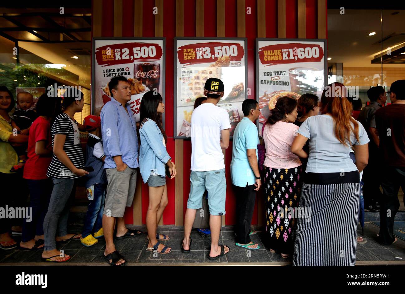 (150702) -- YANGON, July 2, 2015 -- People wait to buy fried chicken outside a KFC branch in Yangon, Myanmar, July 2, 2015. Leading fast food brand KFC opened its first branch in Myanmar on June 30. ) MYANMAR-YANGON-KFC-OPENING UxAung PUBLICATIONxNOTxINxCHN   150702 Yangon July 2 2015 Celebrities Wait to Buy Fried Chicken outside a KFC Branch in Yangon Myanmar July 2 2015 Leading Almost Food Brand KFC opened its First Branch in Myanmar ON June 30 Myanmar Yangon KFC Opening UxAung PUBLICATIONxNOTxINxCHN Stock Photo
