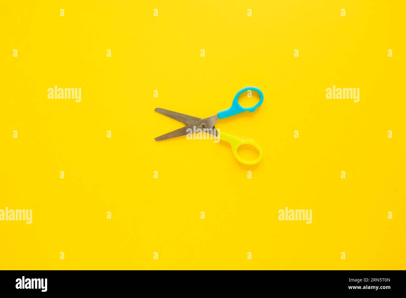 Opened scissors laid middle Stock Photo