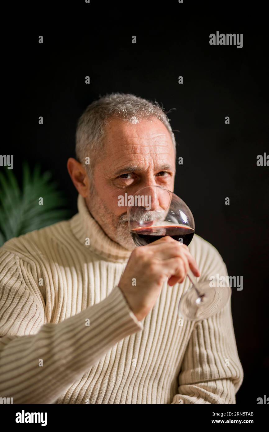 Senior man drinking red wine Stock Photo - Alamy