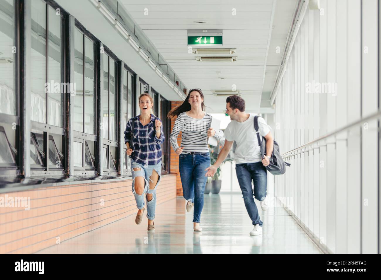 Three students running hi-res stock photography and images - Alamy