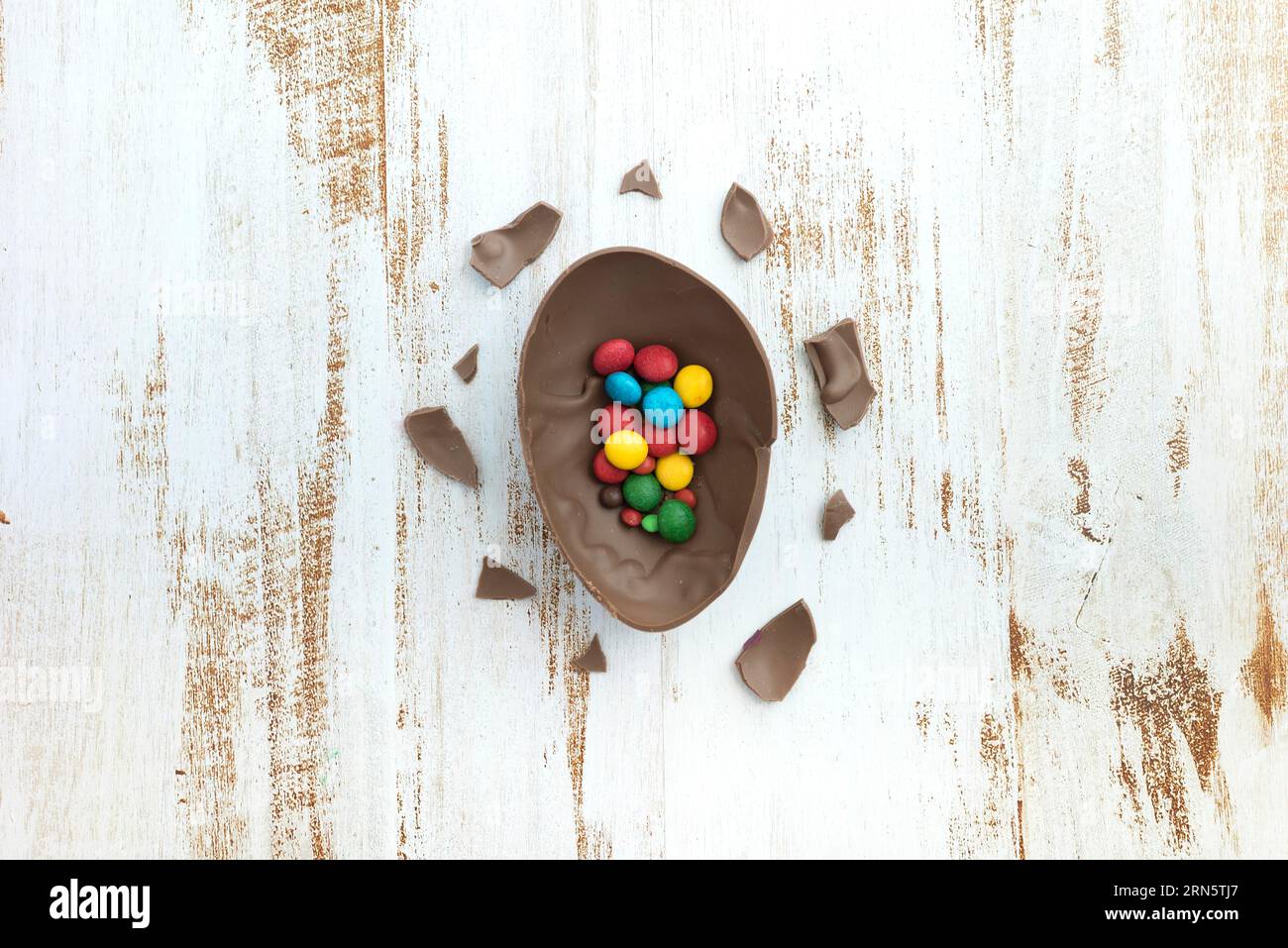 Small candies open chocolate egg table Stock Photo