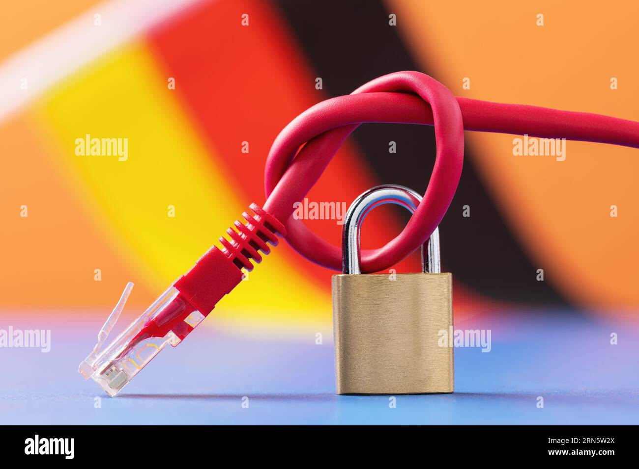 Closed lock on a knotted network wire against the background of the German flag, a concept on the topic of computer network security in Germany Stock Photo