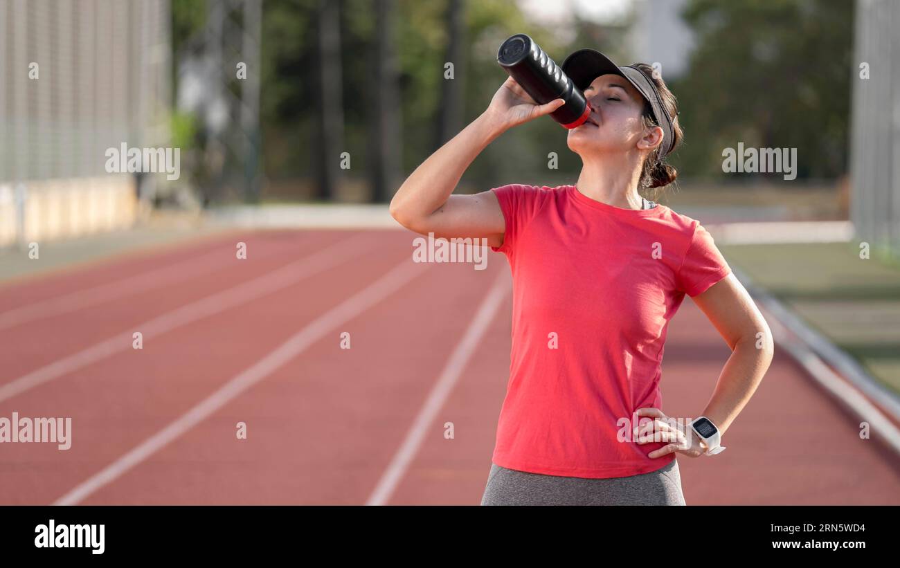 Woman hydration after running Stock Photo Alamy