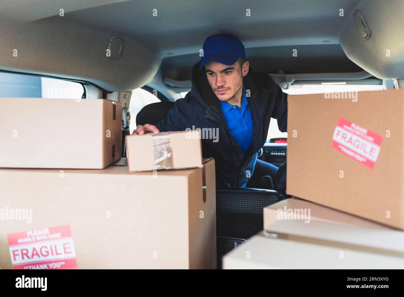 Man car checking boxes delivery Stock Photo