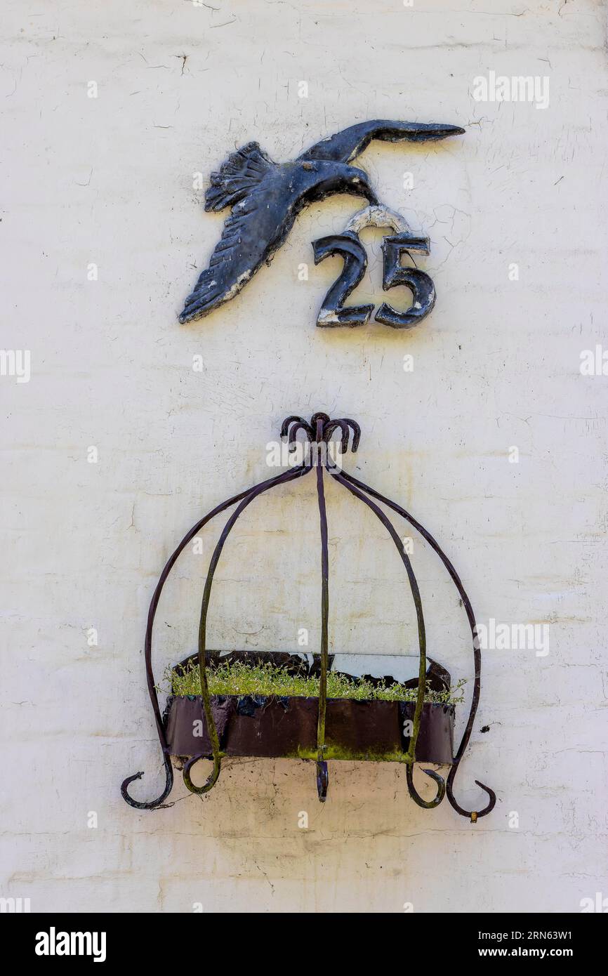 House number and bird relief on the wall of a building, Friedrichstadt, North Frisia, Schleswig-Holstein, Germany Stock Photo