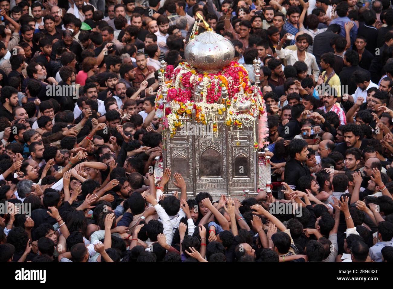 Pakistani Shiite Muslims attend a mourning procession to mark the death ...