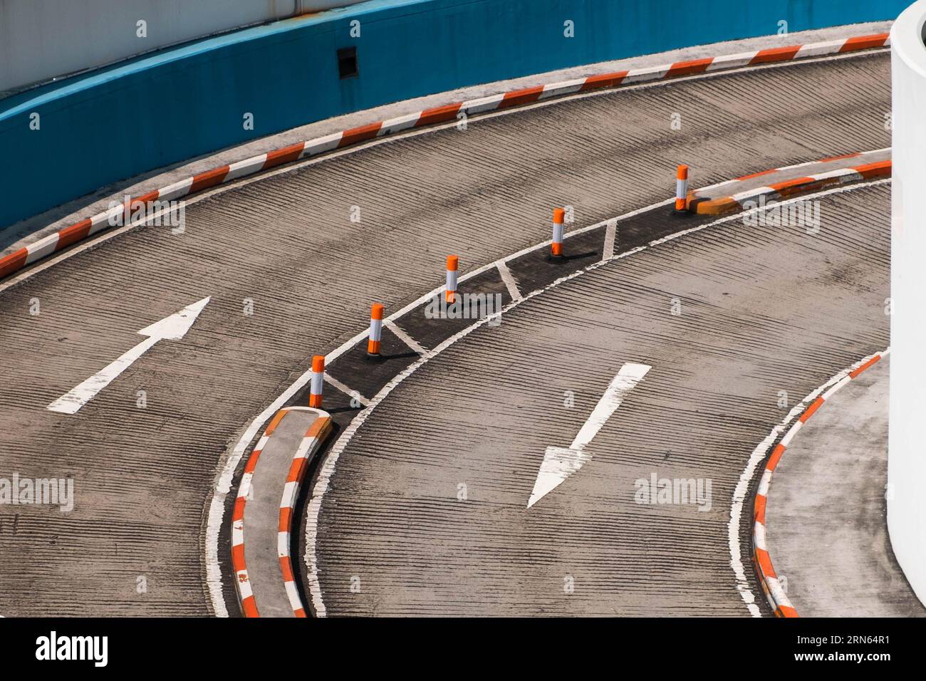 two lane road curve with direction arrows on asphalt Stock Photo