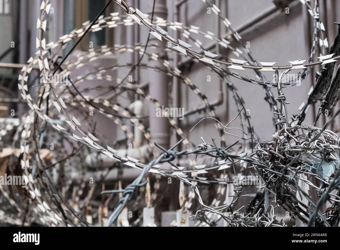 barbwire closeup, fence with barb wire securing property Stock Photo