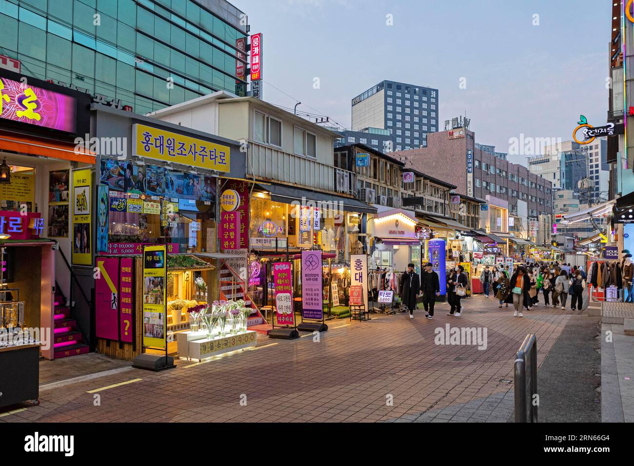 Colourful shops in the evening, neon signs, Hongdae student district, Seoul Stock Photo