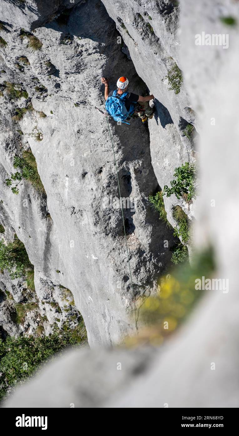 Climber on the rope, multi-pitch climbing, Via la Bellezza della Venere climbing tour, Garda Mountains, Arco, Trentino-Alto Adige, Italy Stock Photo