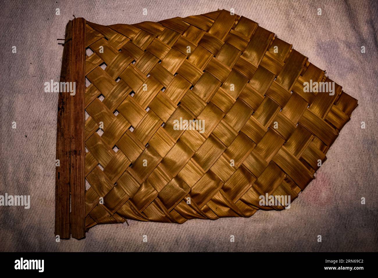 Fan made of braided natural straw, a native fan made of palm leaves, an