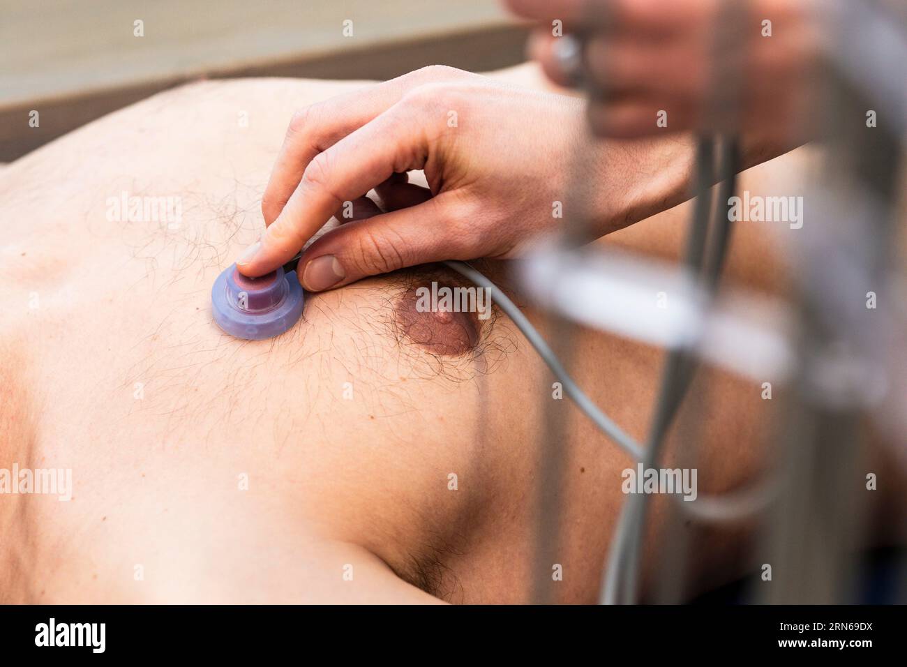 ECG examination by a doctor, application of an electrode Stock Photo