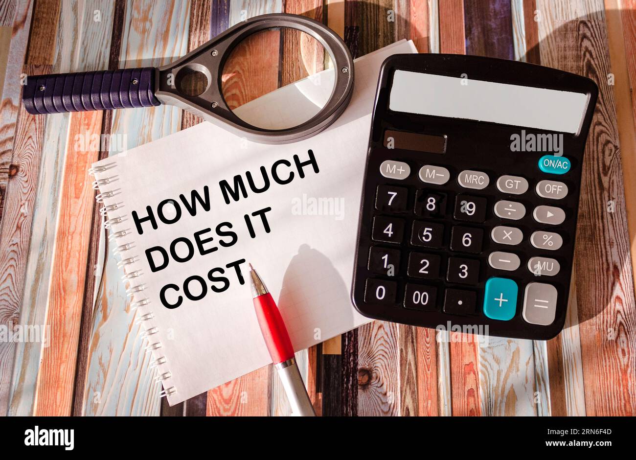 How much does it cost, write on notepad and vintage table with
