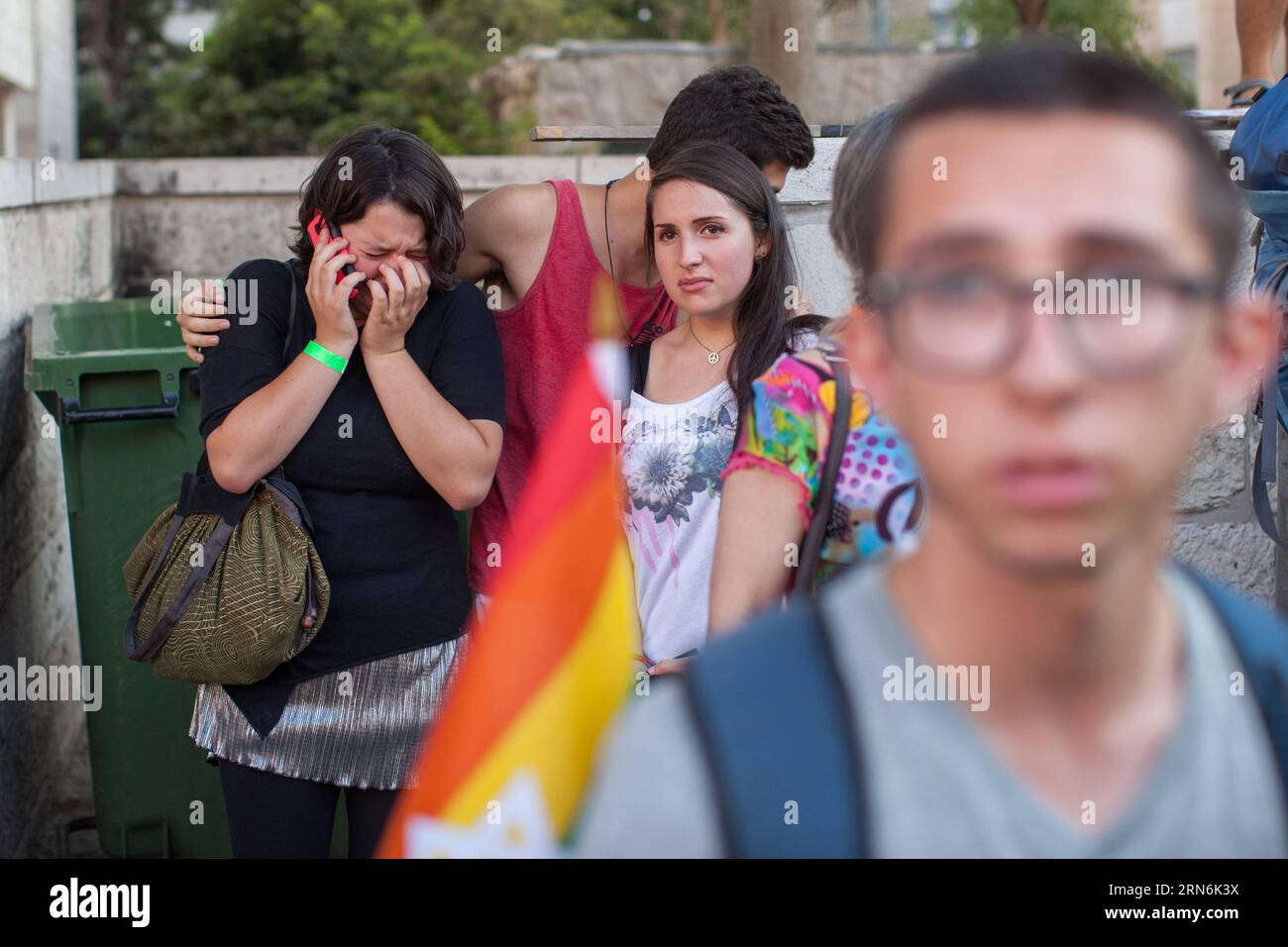 (150730) -- JERUSALEM, July 30, 2015 -- A woman cries while making a phone call after a stabbing attack during the annual gay pride parade in Jerusalem, on July 30, 2015. Six people were stabbed at Jerusalem s annual gay pride parade on Thursday, in one of the gravest attacks on the gay community in Israel, Israeli officials and eyewitnesses told Xinhua. A police spokesperson said the assailant was captured and identified as Yishai Schlissel, a Jewish ultra-Orthodox man who carried out a similar attack in 2005, injuring three people. Schlissel was released from prison only three weeks ago. /Em Stock Photo