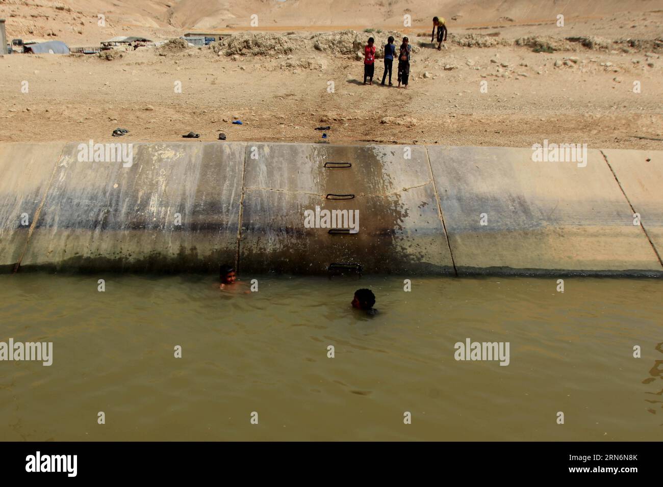 (150803) -- Amman, Aug. 2, 2015 -- Two Jordanian Young Boys Swim In A 