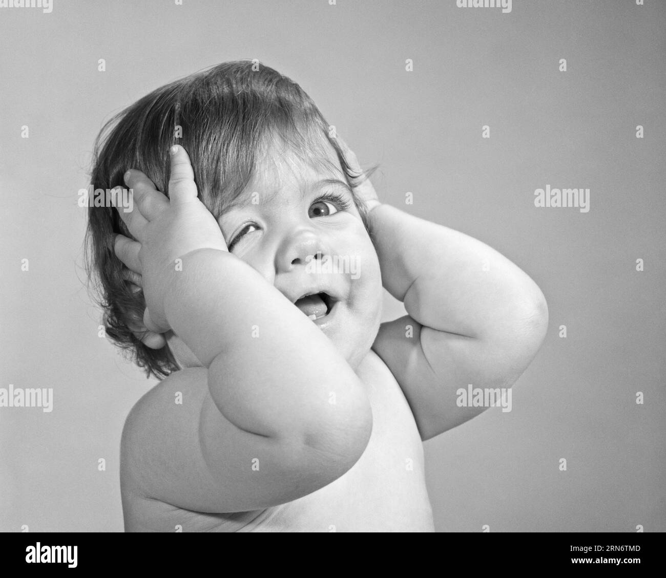 1960s FUNNY FACIAL EXPRESSION BABY GIRL HOLD HEAD WITH HER HANDS PULLING DOWN ONE EYE - b22733 HAR001 HARS COPY SPACE GESTURING EXPRESSIONS B&W EYE CONTACT HUMOROUS HEAD AND SHOULDERS EXCITEMENT COMICAL GESTURES COMEDY PLEASANT AGREEABLE CHARMING GROWTH JUVENILES LOVABLE PLEASING ADORABLE APPEALING BLACK AND WHITE CAUCASIAN ETHNICITY HAR001 OLD FASHIONED Stock Photo