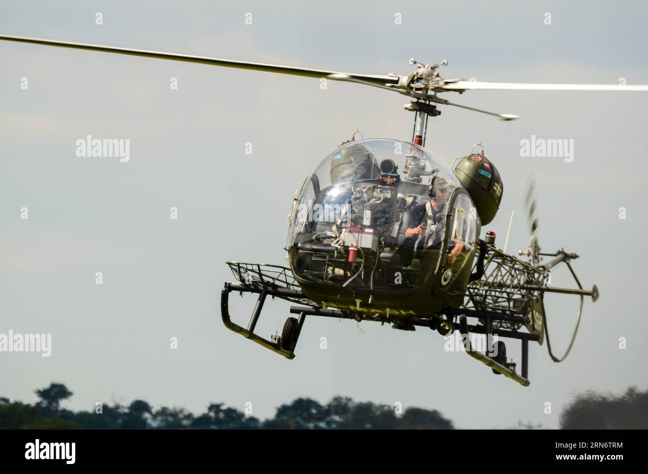 Bell 47G vintage helicopter G-MASH representing the medical evacuation helicopter used in the TV programme MASH of the Korean War, flying at airshow Stock Photo