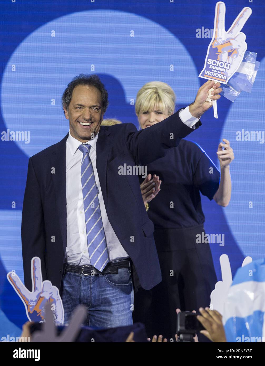 (150810) -- BUENOS AIRES, Aug. 10, 2015 -- The presidential candidate to Argentina s Presidency of ruling party Frente para la Victoria (Front for Victory), Daniel Scioli (L) and his wife Karina Rabolini (R) wave to supporters, at the campaign bunker, in Buenos Aires city, Argentina, early Aug 10, 2015. Scioli received most votes in the national primary elections in Buenos Aires on Sunday, ahead the general elections to be held on October 25th. Argentines voted Sunday in presidential primaries seen as an early indicator of who is best positioned to succeed President Cristina Kirchner. ) ARGENT Stock Photo