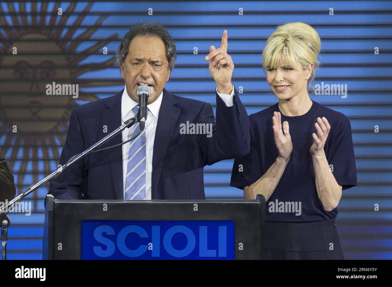 (150810) -- BUENOS AIRES, Aug. 10, 2015 -- The presidential candidate to Argentina s Presidency of ruling party Frente para la Victoria (Front for Victory), Daniel Scioli (L), speaks along with his wife Karina Rabolini (R), at the campaign bunker, in Buenos Aires city, Argentina, early Aug 10, 2015. Scioli received most votes in the national primary elections in Buenos Aires on Sunday, ahead the general elections to be held on October 25th. Argentines voted Sunday in presidential primaries seen as an early indicator of who is best positioned to succeed President Cristina Kirchner. ) ARGENTINA- Stock Photo