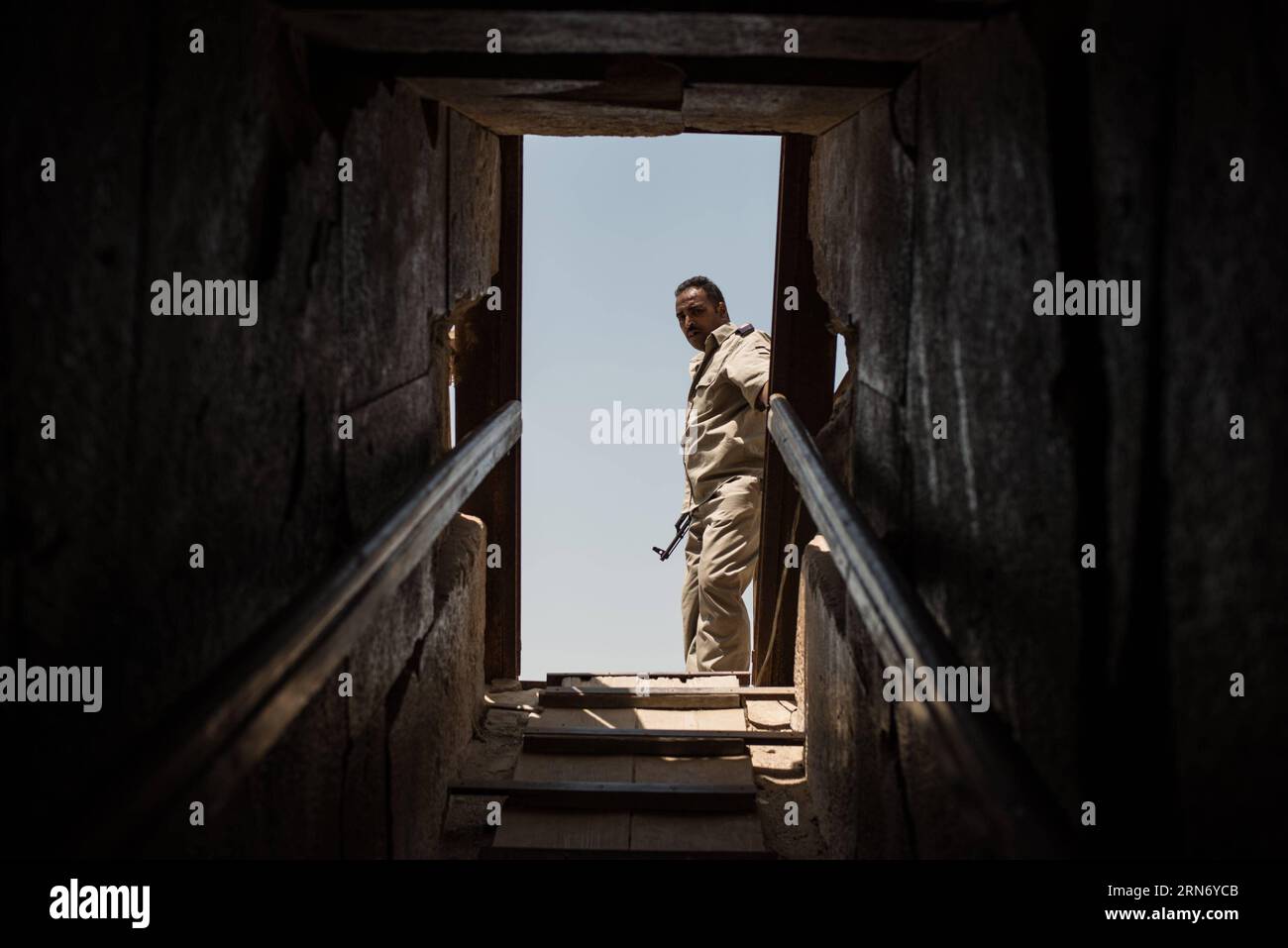 An Egyptian policeman stands guard at the entrance of the Meidum Pyramid in Beni Suef Governorate, about 100 kilometers south to Cairo, Egypt, on Aug. 10, 2015. Meidum Pyramid is thought to be built by the Pharaoh Sneferu, who continued his father Huni s work around 4,600 years ago. ) EGYPT-BENI SUEF-MEIDUM PYRAMID PanxChaoyue PUBLICATIONxNOTxINxCHN   to Egyptian Policeman stands Guard AT The Entrance of The Meidum Pyramid in Beni Suef Governorate About 100 Kilometers South to Cairo Egypt ON Aug 10 2015 Meidum Pyramid IS Thought to Be built by The Pharaoh Sneferu Who Continued His Father Huni Stock Photo