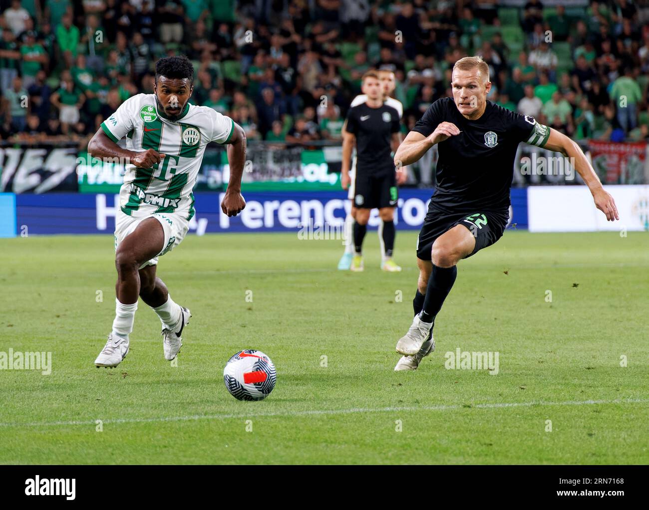 Petrus Boumal of Ujpest FC competes for the ball with Jose Marcos