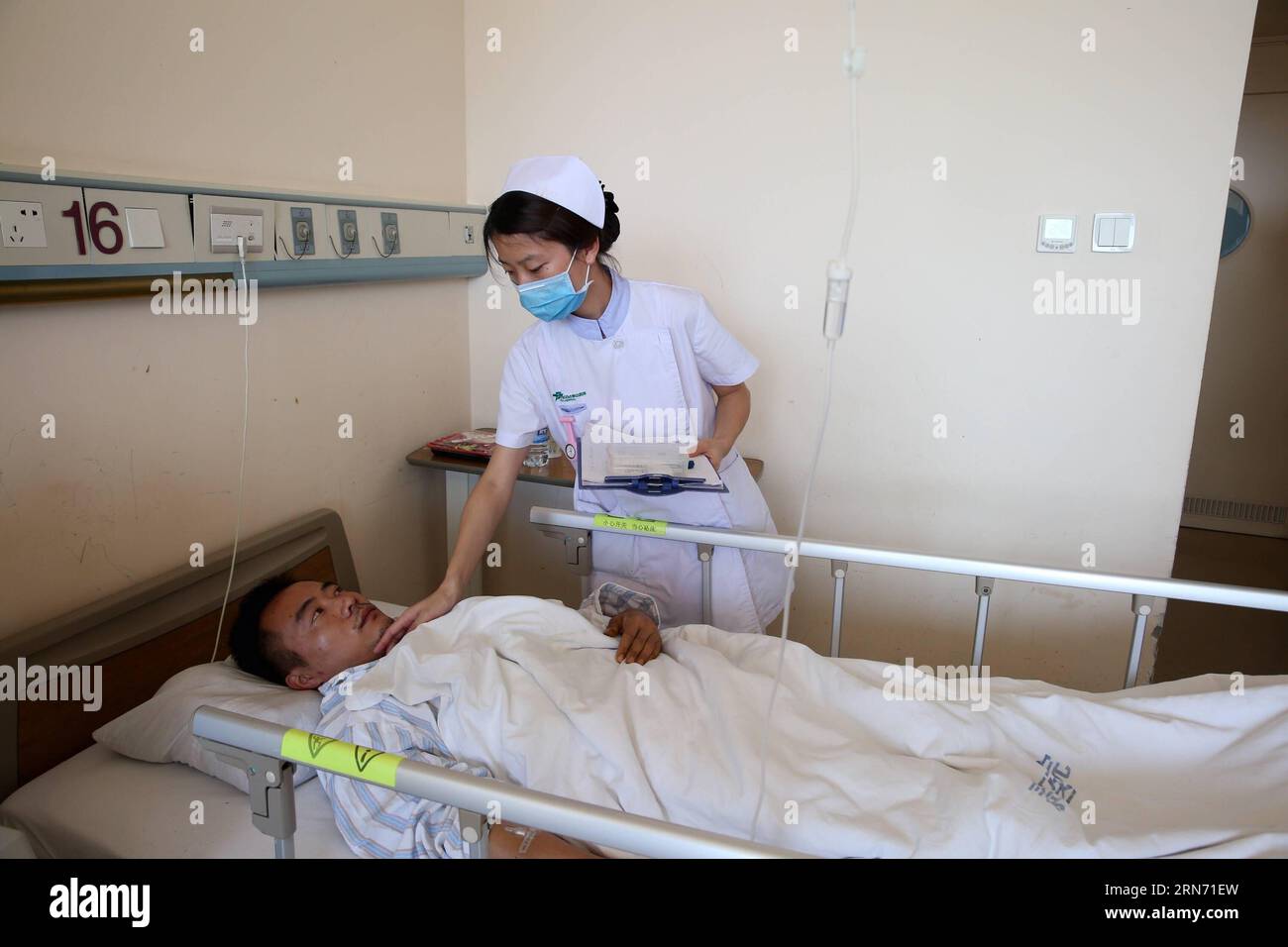 (150813) -- TIANJIN, Aug. 13, 2015 -- Firefighter Li Guangqing receives medical treatment at Taida Hospital in Tianjin, north China, Aug. 13, 2015. The death toll has climbed to 44 from two massive blasts that ripped through a warehouse in north China s port city of Tianjin as of Thursday noon, according to rescue headquarters. Twelve firefighters were among the dead. More than 1,000 firefighters and rescuers are working at the explosion site. ) (lfj) CHINA-TIANJIN-EXPLOSION-FIREFIGHTERS (CN) JinxLiwang PUBLICATIONxNOTxINxCHN   150813 Tianjin Aug 13 2015 Fire Fighter left Guangqing receives Me Stock Photo