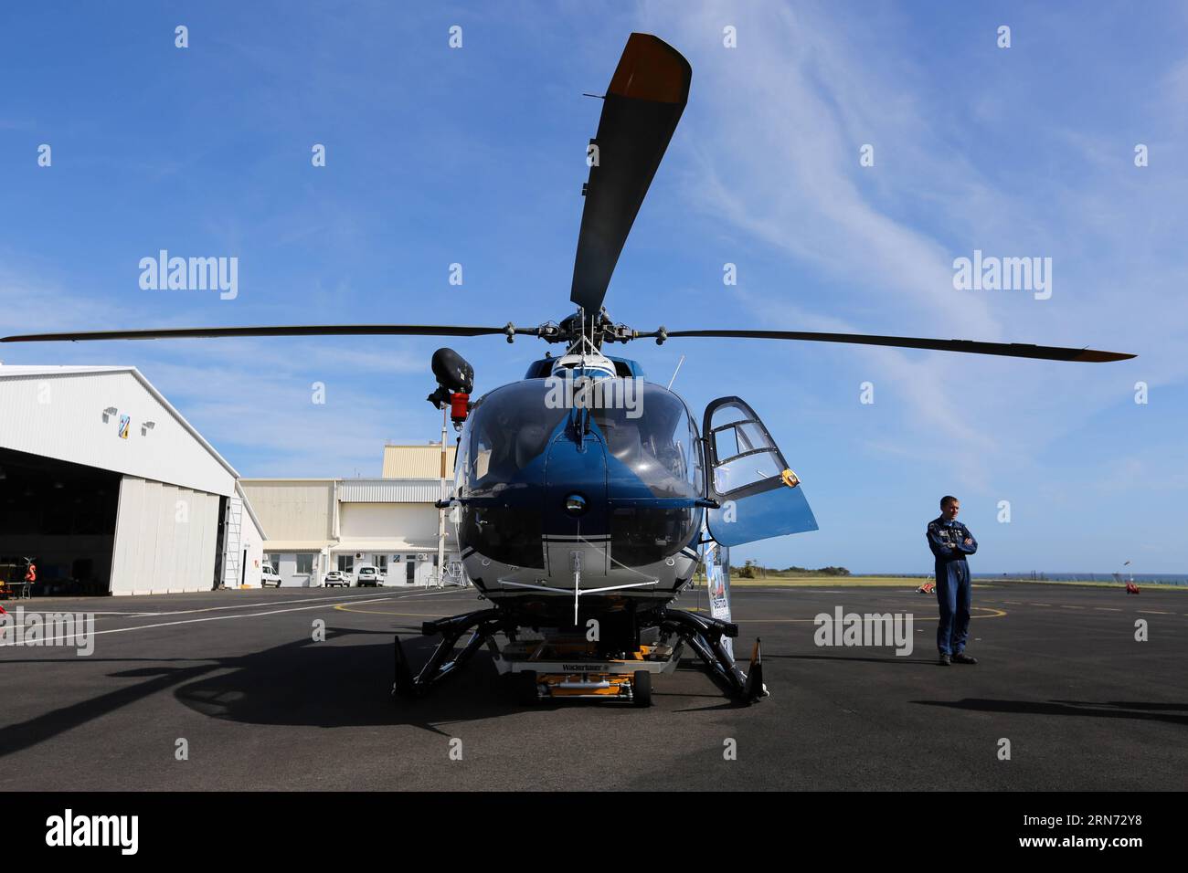 (150814) -- LA REUNION, Aug. 14, 2015 -- A pilot stands near a helicopter taking part in the searching mission at an airport in Saint Denis, La Reunion, Aug. 14, 2015. The administrator of Reunion Island Dominique Sorain told the media on Friday the active search for more MH370 debris will continue until Monday. No debris related to the plane has been found in the sea during the 35 hours of a combined search by a CASA search plane of French army and three helicopters, he said. ) (djj) LA REUNION-MH370 DEBRIS-SEARCH PanxSiwei PUBLICATIONxNOTxINxCHN   150814 La Reunion Aug 14 2015 a Pilot stands Stock Photo