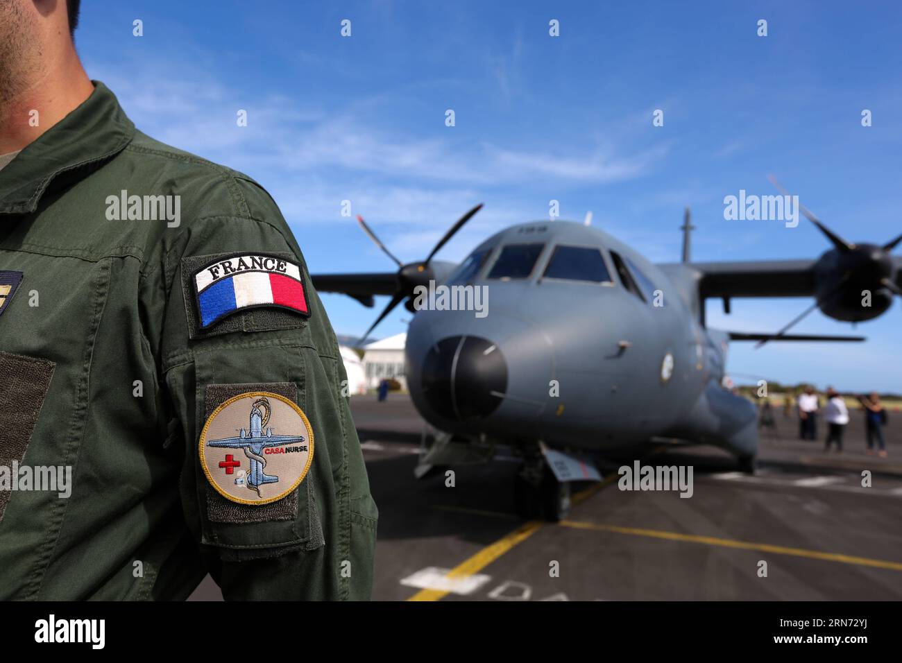 (150814) -- LA REUNION, Aug. 14, 2015 -- A pilot stands near a search plane taking part in the searching mission at an airport in Saint Denis, La Reunion, Aug. 14, 2015. The administrator of Reunion Island Dominique Sorain told the media on Friday the active search for more MH370 debris will continue until Monday. No debris related to the plane has been found in the sea during the 35 hours of a combined search by a CASA search plane of French army and three helicopters, he said. ) (djj) LA REUNION-MH370 DEBRIS-SEARCH PanxSiwei PUBLICATIONxNOTxINxCHN   150814 La Reunion Aug 14 2015 a Pilot stan Stock Photo
