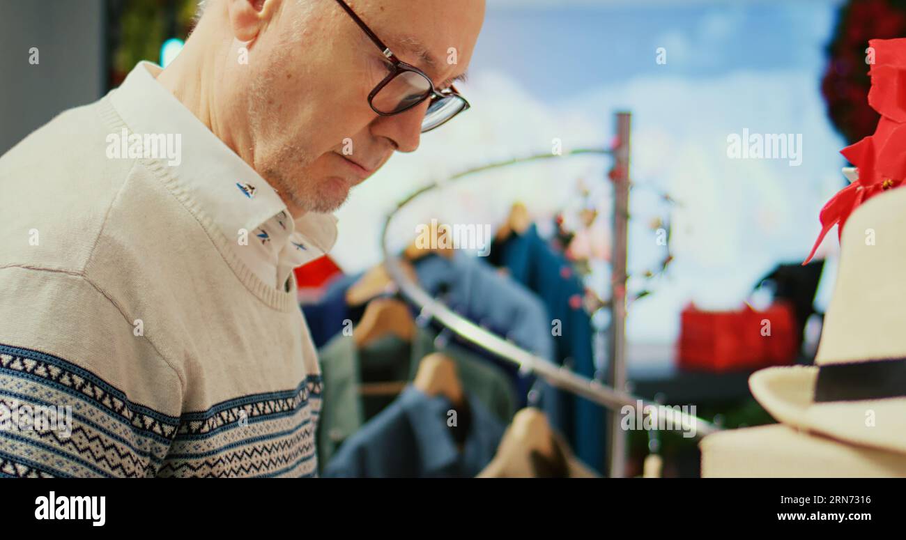 Man Browsing Racks Elderly client browsing through clothes hi-res stock photography and ...