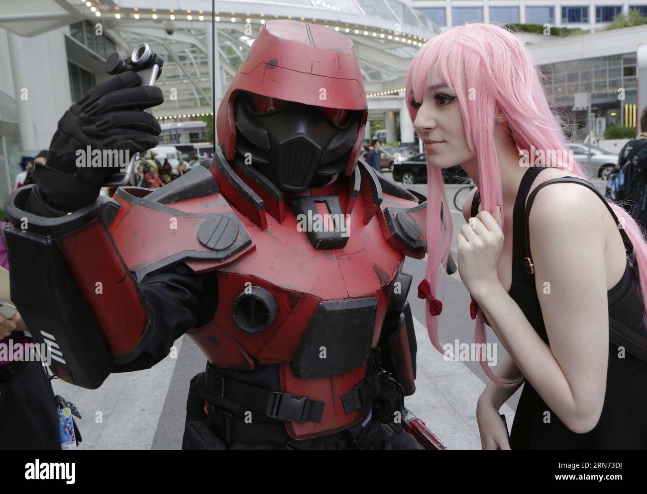 Cosplayers take pictures together during the Anime Revolution event at