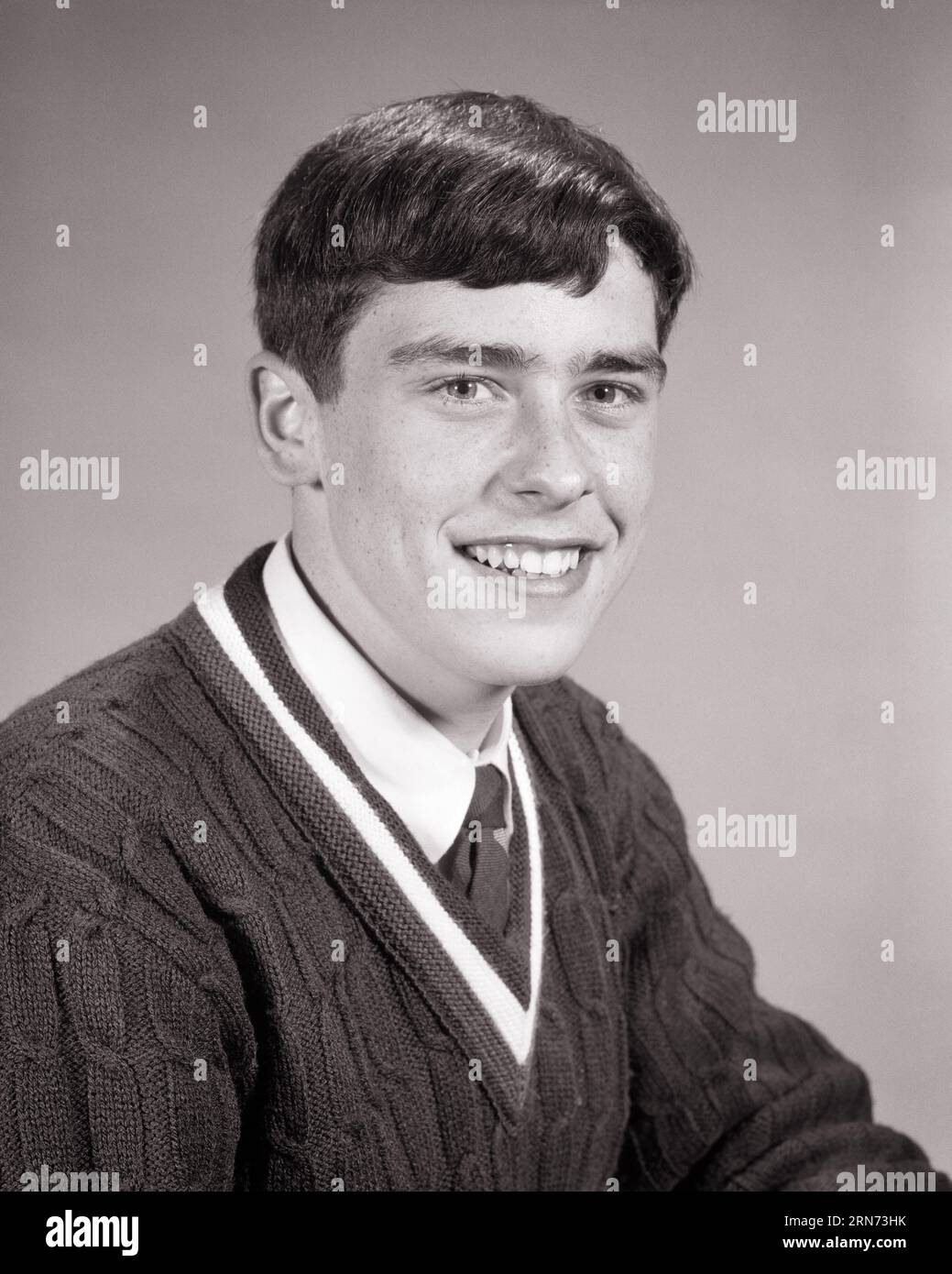 1960s PORTRAIT OF SMILING TEENAGE BOY WEARING VEE NECK SWEATER WITH WHITE SHIRT AND NECK TIE - p7166 HAR001 HARS TEENAGE BOY CONFIDENCE B&W EYE CONTACT BRUNETTE SCHOOLS HAPPINESS HEAD AND SHOULDERS CHEERFUL AND PRIDE HIGH SCHOOL SMILES HIGH SCHOOLS JOYFUL STYLISH TEENAGED JUVENILES VEE BLACK AND WHITE CAUCASIAN ETHNICITY HAR001 OLD FASHIONED Stock Photo