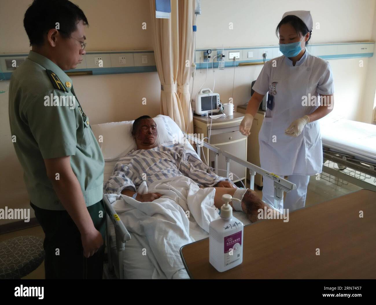 (150816) -- TIANJIN, Aug. 16, 2015 -- A nurse takes care of the rescued firefighter Zhou Ti in Taida Hospital in north China s Tianjin Municipality, Aug. 16, 2015. Zhou has recovered smoothly and can have slop for food on Sunday. ) (zwx) CHINA-TIANJIN-EXPLOSION-RESCUED FIREFIGHTER(CN) LvxDong PUBLICATIONxNOTxINxCHN   150816 Tianjin Aug 16 2015 a Nurse Takes Care of The Rescued Fire Fighter Zhou Ti in  Hospital in North China S Tianjin Municipality Aug 16 2015 Zhou has recovered smoothly and CAN have slop for Food ON Sunday zwx China Tianjin Explosion Rescued Fire Fighter CN  PUBLICATIONxNOTxIN Stock Photo