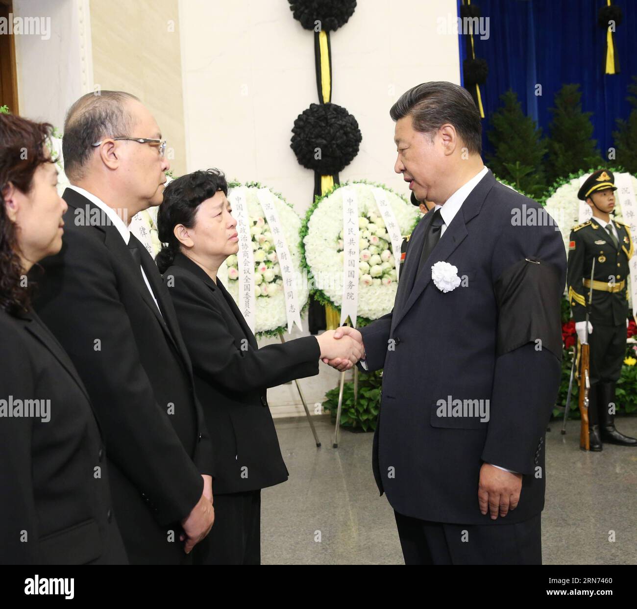 (150816) -- BEIJING, Aug. 16, 2015 -- Chinese President Xi Jinping (R, front) shakes hands with a family member of Wei Jianxing, former head of China s top anti-graft body the Central Commission for Discipline Inspection of the Communist Party of China, during Wei s funeral at Babaoshan Revolutionary Cemetery in Beijing, capital of China, Aug. 16, 2015. President Xi Jinping, Premier Li Keqiang and senior leaders Zhang Dejiang, Yu Zhengsheng, Liu Yunshan, Wang Qishan and Zhang Gaoli, as well as former president Hu Jintao attended the funeral on Friday morning. Former president Jiang Zemin, who Stock Photo