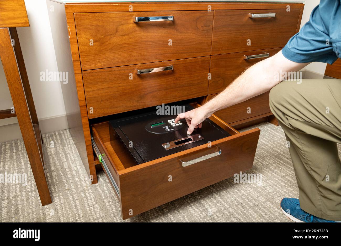 Hand opening safe in hotel room to store valuables Stock Photo Alamy