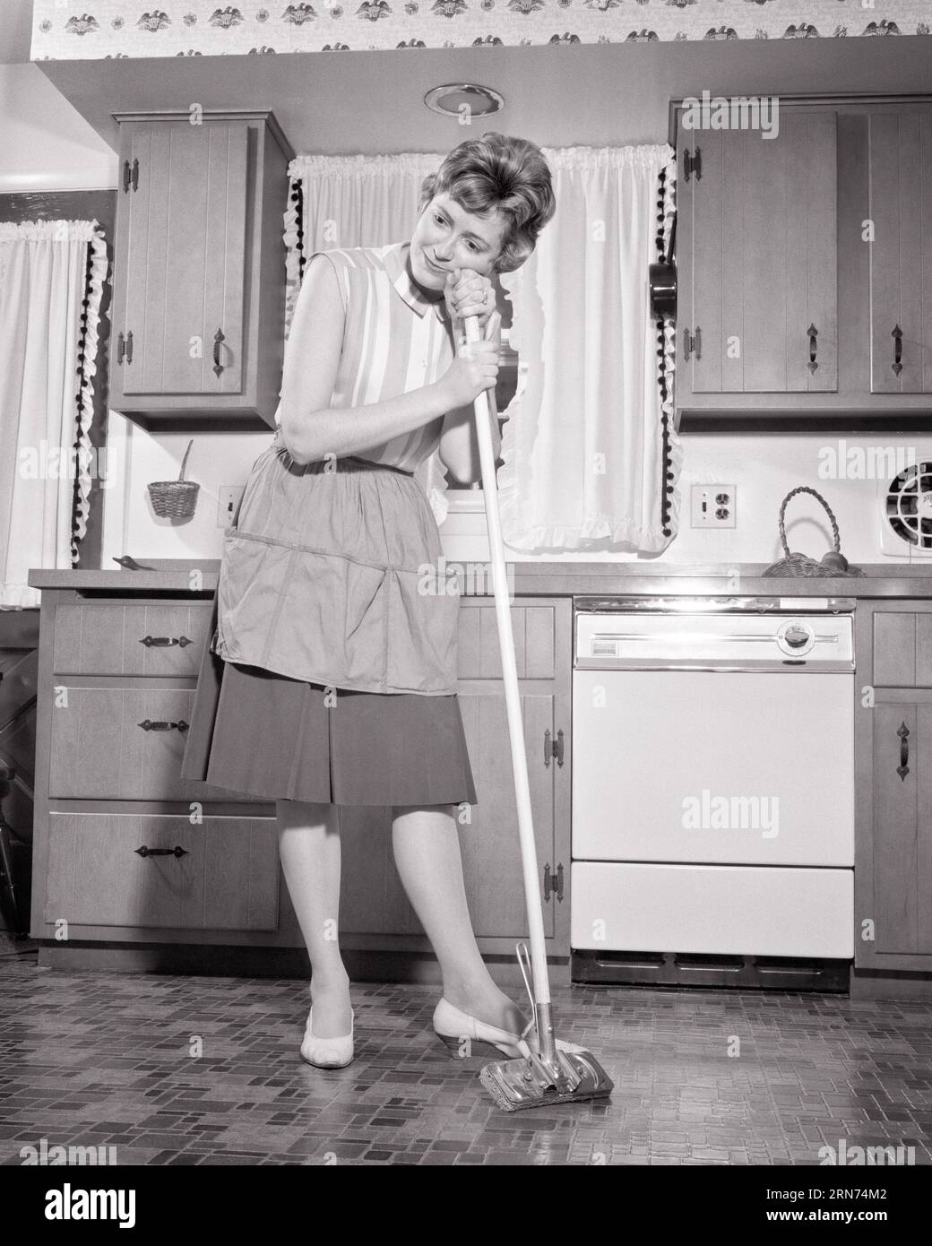https://c8.alamy.com/comp/2RN74M2/1960s-woman-housewife-leaning-on-handle-of-sponge-mop-in-the-kitchen-tired-but-proud-of-newly-waxed-floor-h7120-har001-hars-chores-females-proud-moody-home-life-full-length-ladies-persons-expressions-troubled-bw-concerned-sadness-homemaker-dreams-homemakers-chore-choice-low-angle-sponge-housewives-mood-mopping-occupations-conceptual-glum-handle-waxed-dejected-mid-adult-mid-adult-woman-miserable-newly-task-black-and-white-caucasian-ethnicity-har001-old-fashioned-2RN74M2.jpg