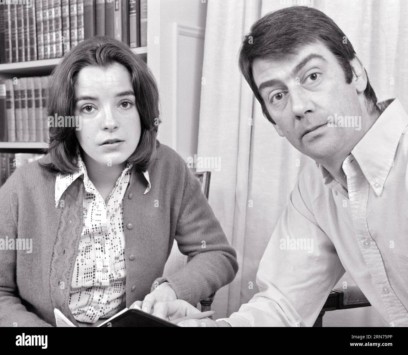 1970s PORTRAIT OF MAN AND WOMAN LOOKING AT CAMERA WITH SERIOUS FACIAL