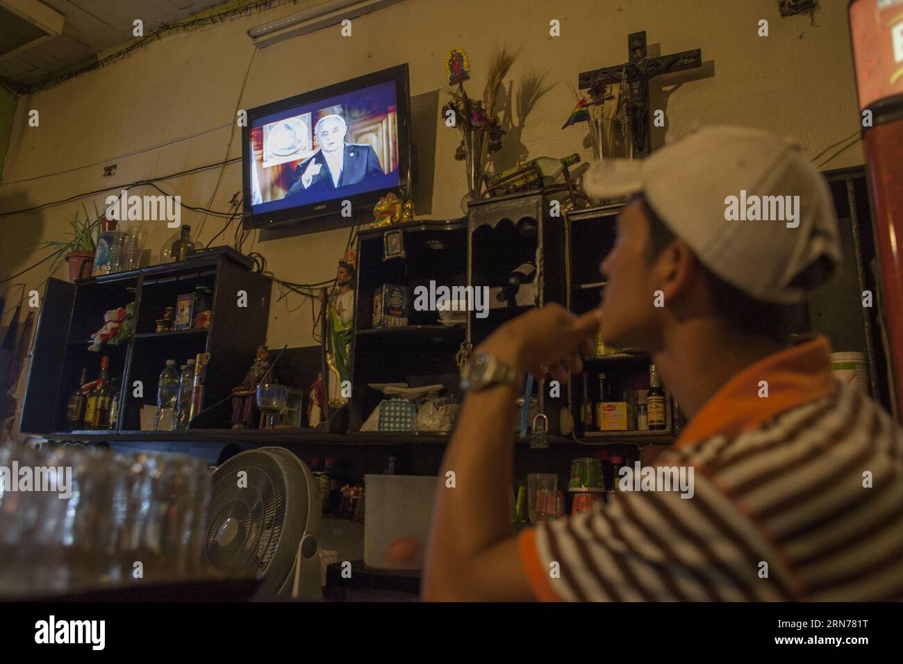 (150824) -- GUATEMALA CITY, Aug. 23, 2015 -- A man watches TV as Guatemala s President Otto Perez Molina delivering a speech, in Guatemala City, Guatemala, on Aug. 23, 2015. President Otto Perez Molina says he won t resign from office despite investigators saying he may have been involved in a customs fraud scandal that has thrown the country into political crisis. Luis Echeverria) GUATEMALA-GUATEMALA CITY-OTTO PEREZ MOLINA e LuisxEcheverria PUBLICATIONxNOTxINxCHN   150824 Guatemala City Aug 23 2015 a Man Watches TV As Guatemala S President Otto Perez Molina Delivering a Speech in Guatemala Ci Stock Photo