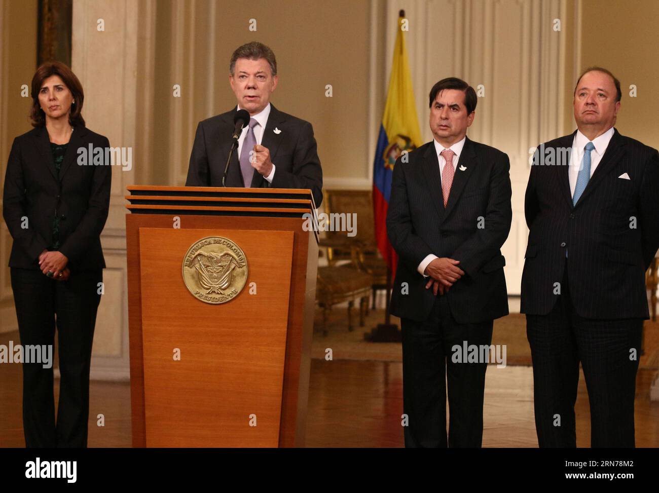 BOGOTA, Aug. 25, 2015 -- Image provided by shows Colombian President Juan Manuel Santos (2nd, L) delivering a speech, accompanied by the Colombian Foreign Minister Maria Angela Holguin (1st, L), Minister of Interior Juan Fernando Cristo (2nd, R) and Defense Minister Luis Carlos Villegas (1st, R), at the Narino Palace in Bogota, Colombia, on Aug. 25, 2015. Juan Manuel Santos reiterated that the differences between Colombia and Venezuela can be overcome with dialogue and diplomacy , following the closure of an important border post between the two countries. Nelson Cardenas/) (jp) COLOMBIA-BOGOT Stock Photo