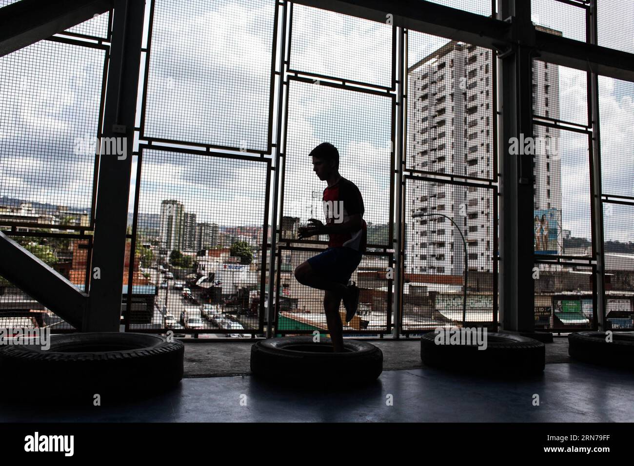 Image taken on Aug. 26, 2015 shows a young man attending a boxing training at El Dorado Vertical Gym, located in Francisco de Miranda avenue, in Buena Vista sector of Petare, Sucre municipality, Caracas Metropolitan Area, Venezuela. The Juan Montoya boxing academy, currently located at El Dorado Vertical Gym, is one of the schools serving the zones of Petare for 16 years, training the future boxers. One of the initiatives of the academy is to bring the sport closer to the communities through the training of young people. It has 7 floors, 4 of them designed for sports in the municipality, offer Stock Photo