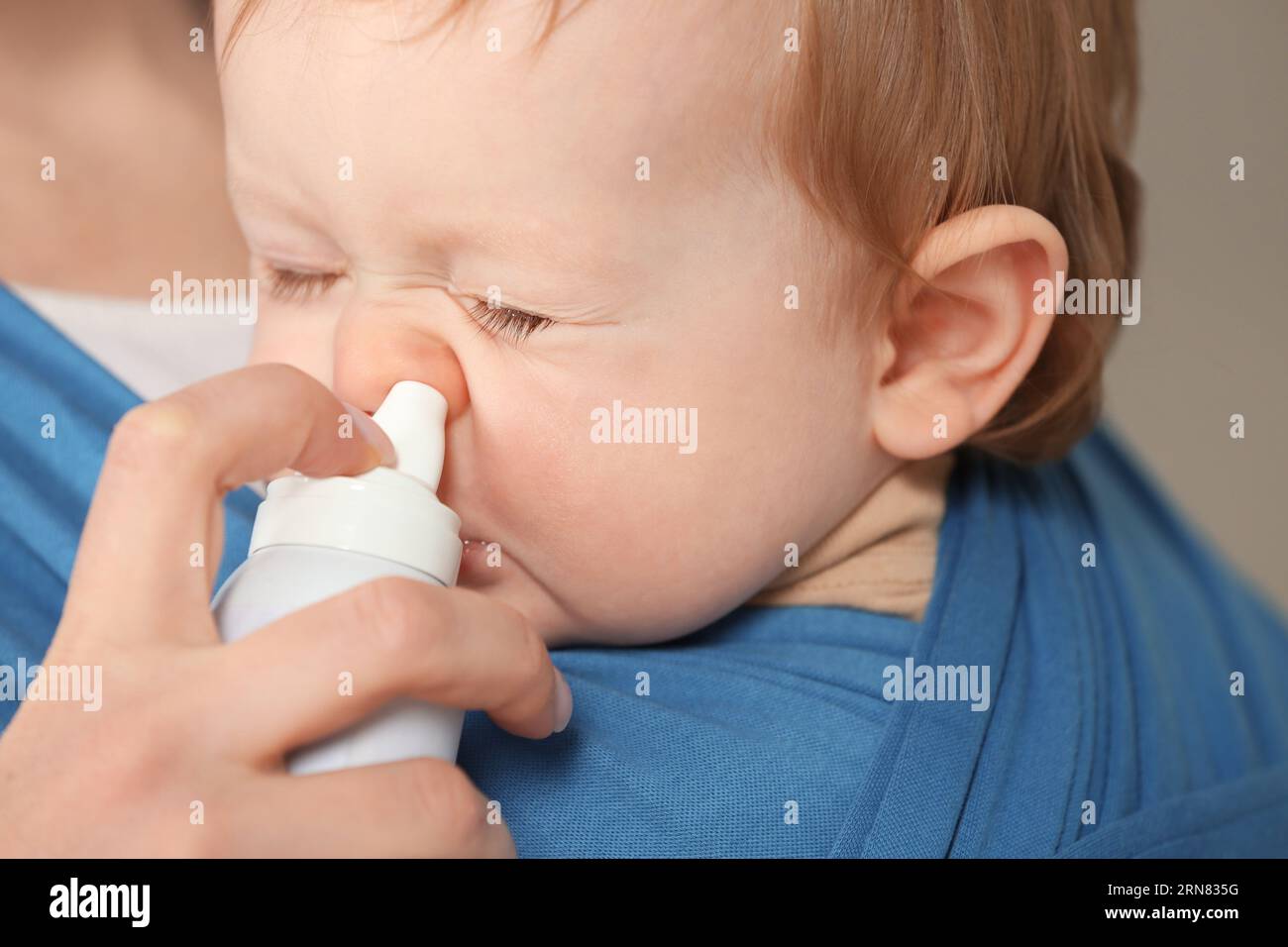 Mother helping her baby to use nasal spray, closeup Stock Photo Alamy