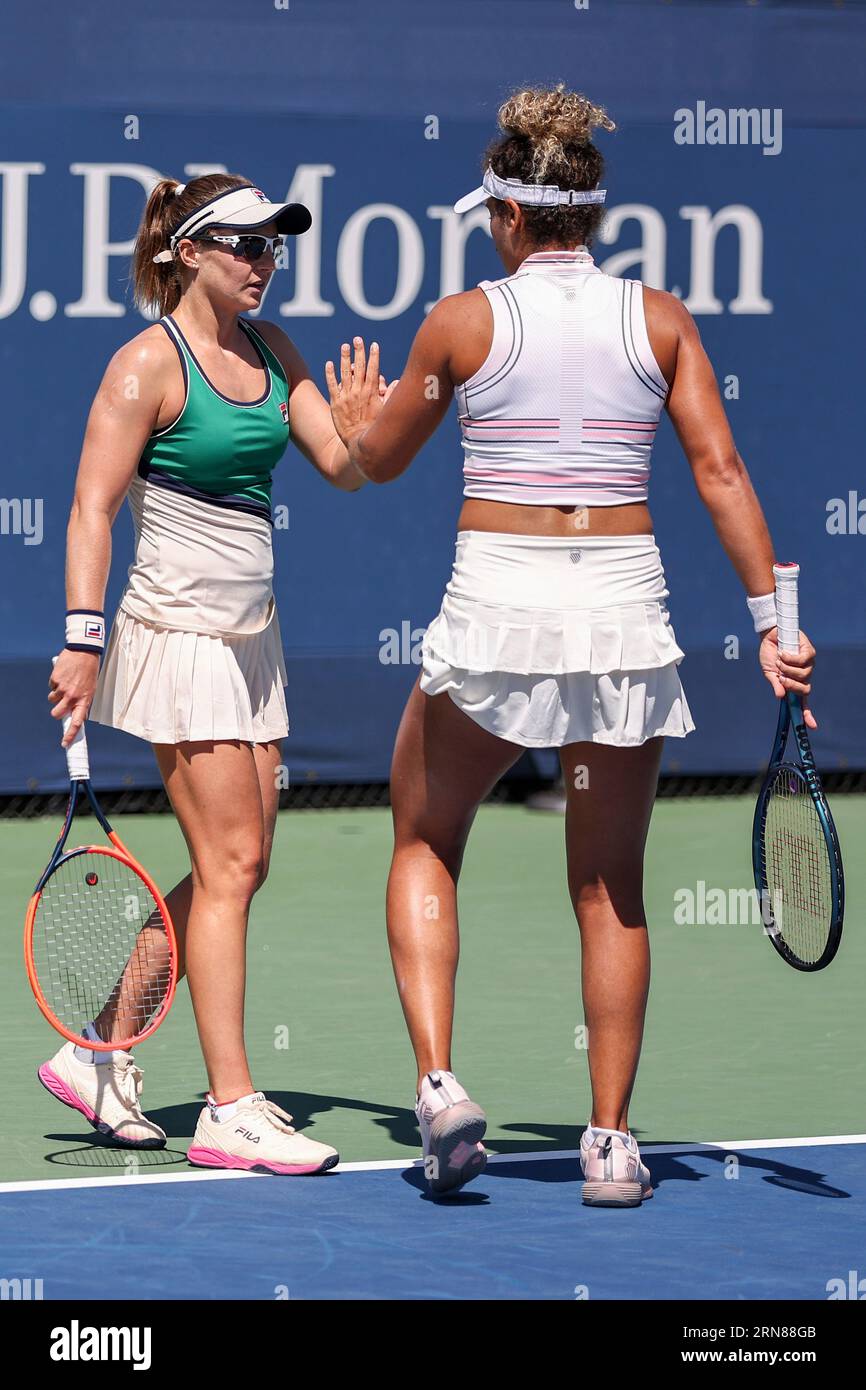 Nadia Podoroska and Mayar Sherif high five during a womens doubles match at the 2023 US Open, Thursday, Aug