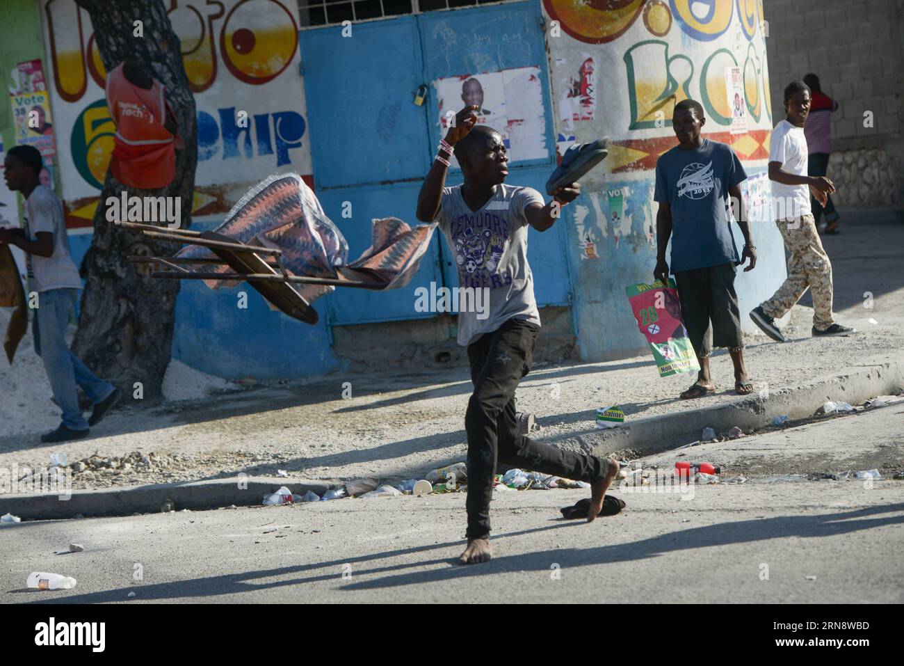 (151107) -- PORT-AU-PRINCE, Nov. 6, 2015 -- A youngster reacts while the police disperse demonstrators during a rally against the results of the presidential elections in Port-Au-Prince, Haiti, on Nov. 6, 2015. Residents took to the streets of the Haitian capital on Friday to express rejection to the results of the last presidential elections, while the government reaffirmed its support to the electoral process and guaranteed that it will keep the order in the country. Supporters of Celestin and Jean-Charles, second and third according to the counting of the votes, marched in the Delmas munici Stock Photo