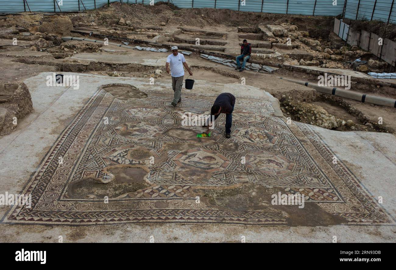 LOD (ISRAEL),  Workers clean up a patch of the 1,700-year-old mosaic in Lod, a city east of Tel Aviv in central Israel, on Nov. 16, 2015. Israel s Antiquities Authority unveiled Monday a Roman-era floor mosaic, which was unearthed last year during constructions of a visitor center meant to exhibit another mosaic discovered two decades ago in the same place. Archaeologists said that the breathtaking mosaic served as a floor of a villa s living room some 1,700 years ago. ) ISRAEL-LOD-MOSAIC-UNCOVERING LixRui PUBLICATIONxNOTxINxCHN   Lod Israel Workers Clean up a Patch of The 1 700 Year Old Mosai Stock Photo