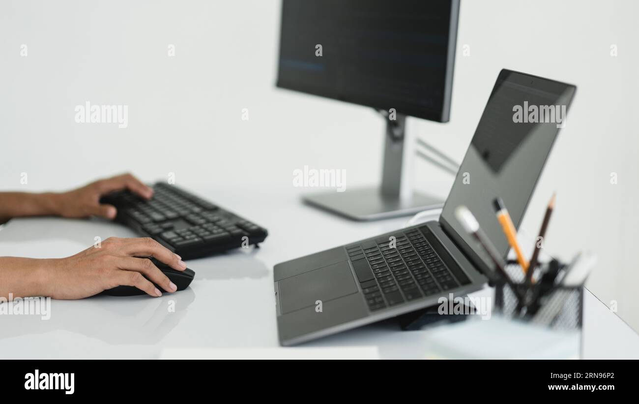 Hands of developer programmer using mouse and typing on keyboard to programming and developing web. Stock Photo