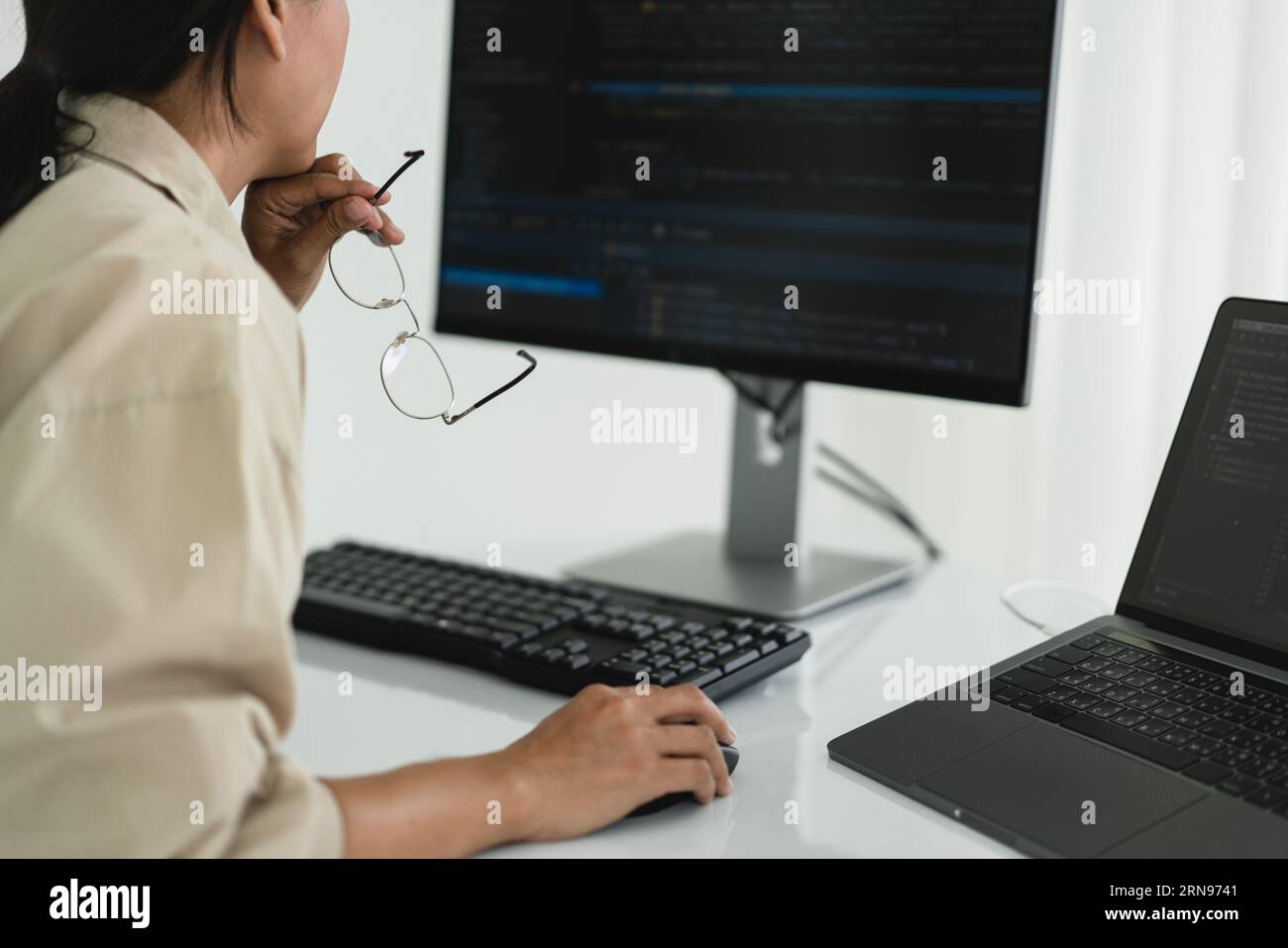Developer programmer checking code on monitor while programming to developing web and application. Stock Photo