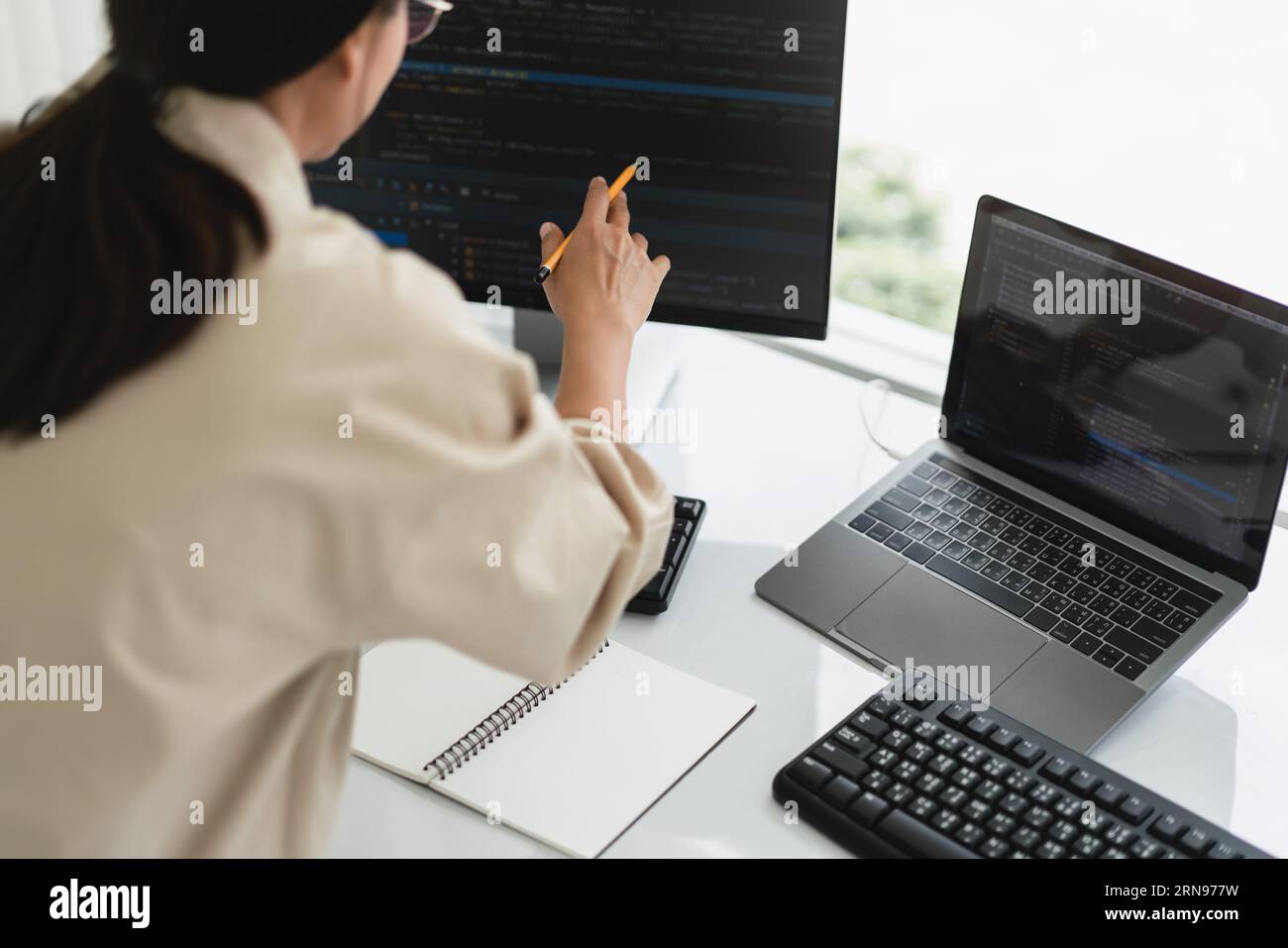 Developer programmer checking code on monitor while programming to developing web and application. Stock Photo