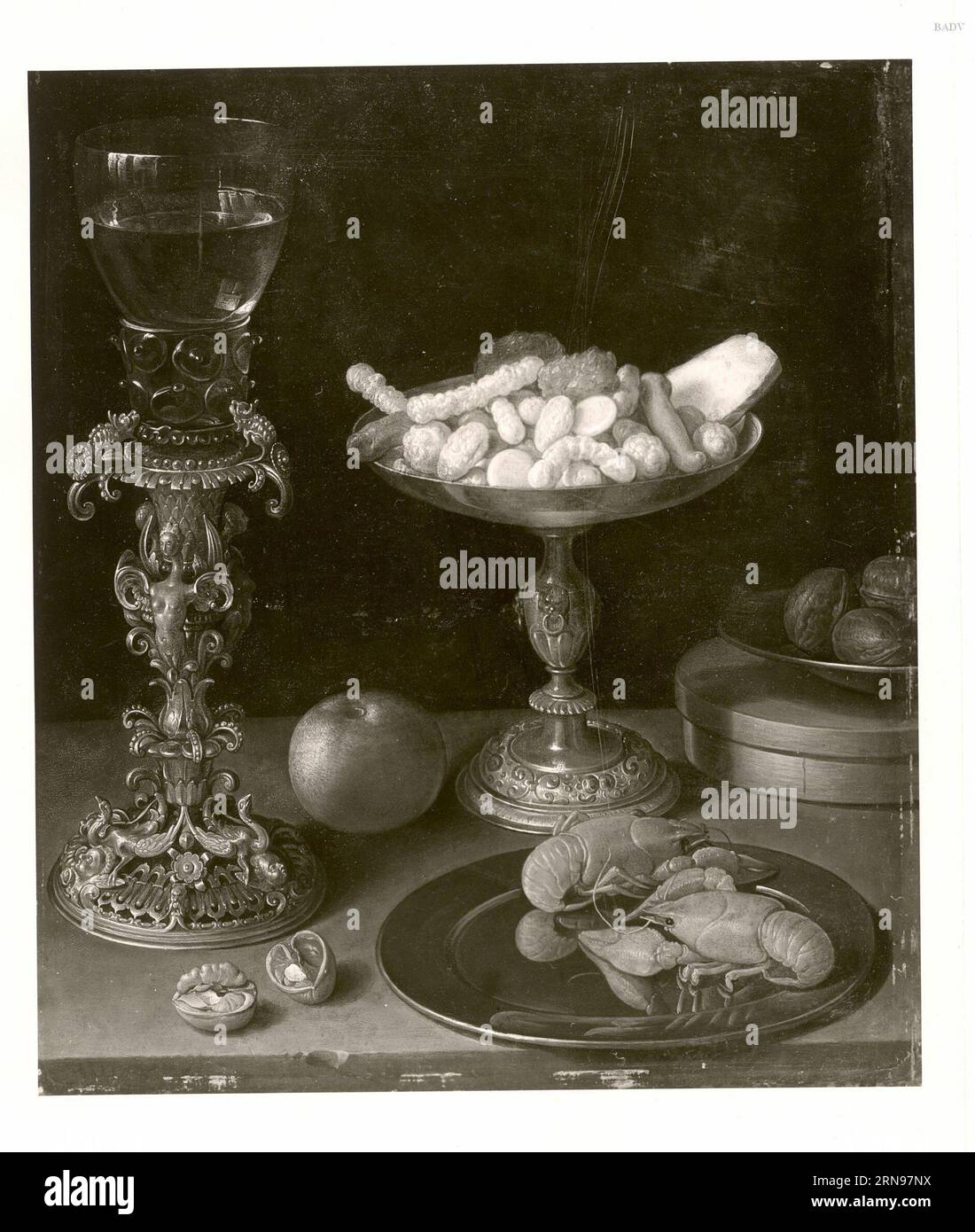A roemer on a silver-gilt bekerschroef, sweetmeats in a silver tazza, langoustines on a plate, walnuts and an apple on a table top 1607 by Jeremias van Winghe Stock Photo
